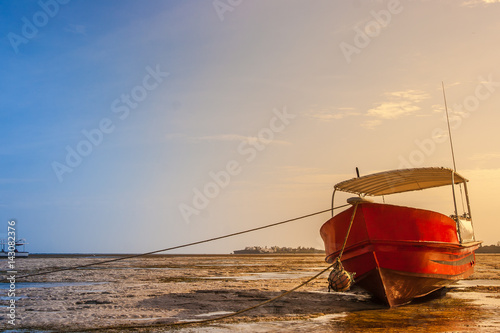 Low tide. The boat lies on the sand during the low tide of the Indian Ocean.