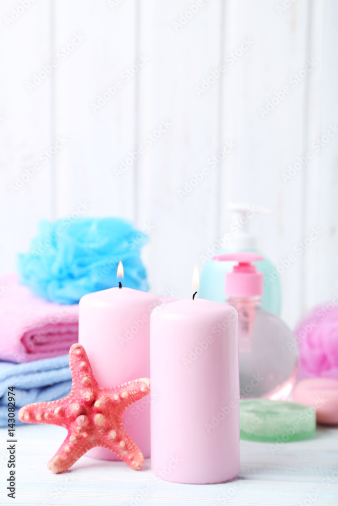 Pink candles with starfish on white wooden table Pink candles with starfish on white wooden table
