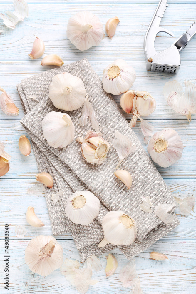 Garlic with napkin on blue wooden table