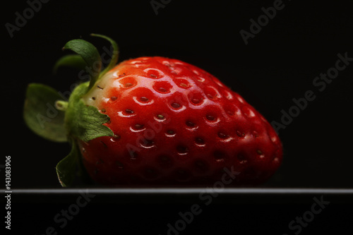 strawberry on black dish 