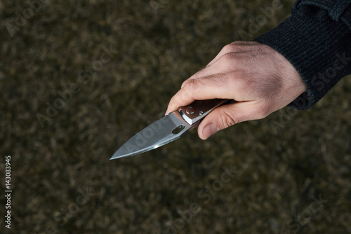 Man holding pocket knife in hand close up