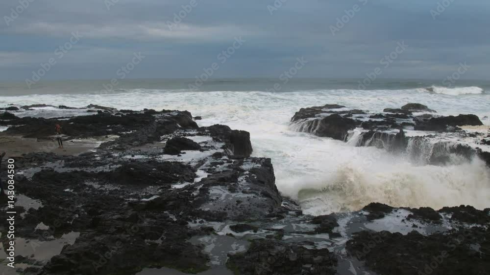 Waves crashing on rocky kicking up mist Waves crashing on rocky kicking up mist