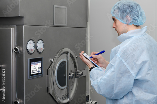 The specialist conducts an inspection of pharmaceutical equipment