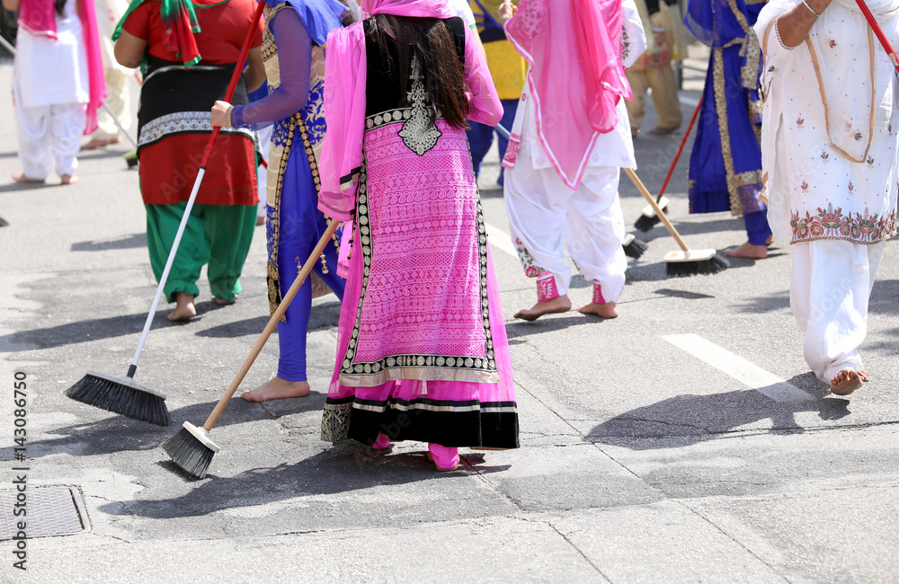 many Sikhs  women barefoot while scavenging the road