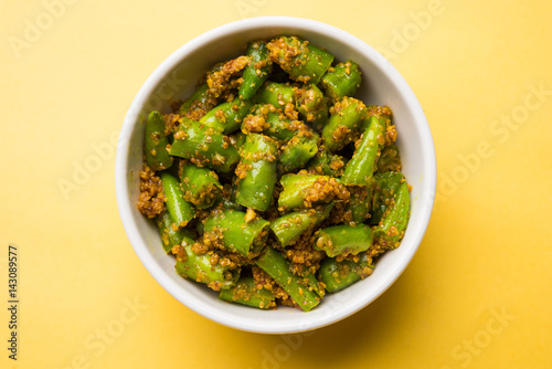closeup picture of  Homemade hari mirch ka achar or green chilli pickle in a white bowl, selective focus