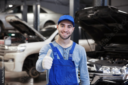 Young mechanic standing in ...