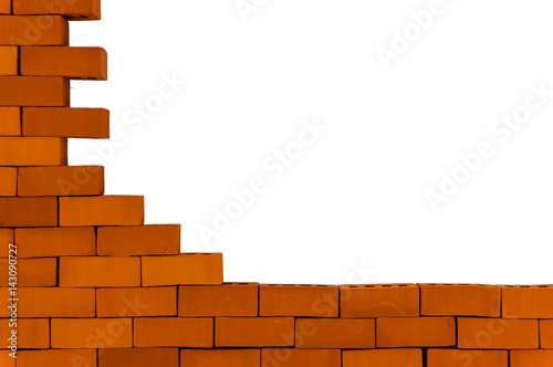 A piece of a brick wall on a white background. Unfinished brick wall.