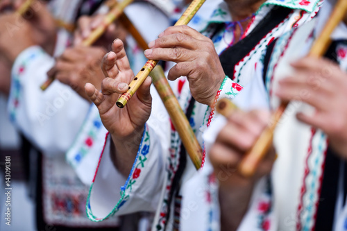 People singing at traditional wooden flutes