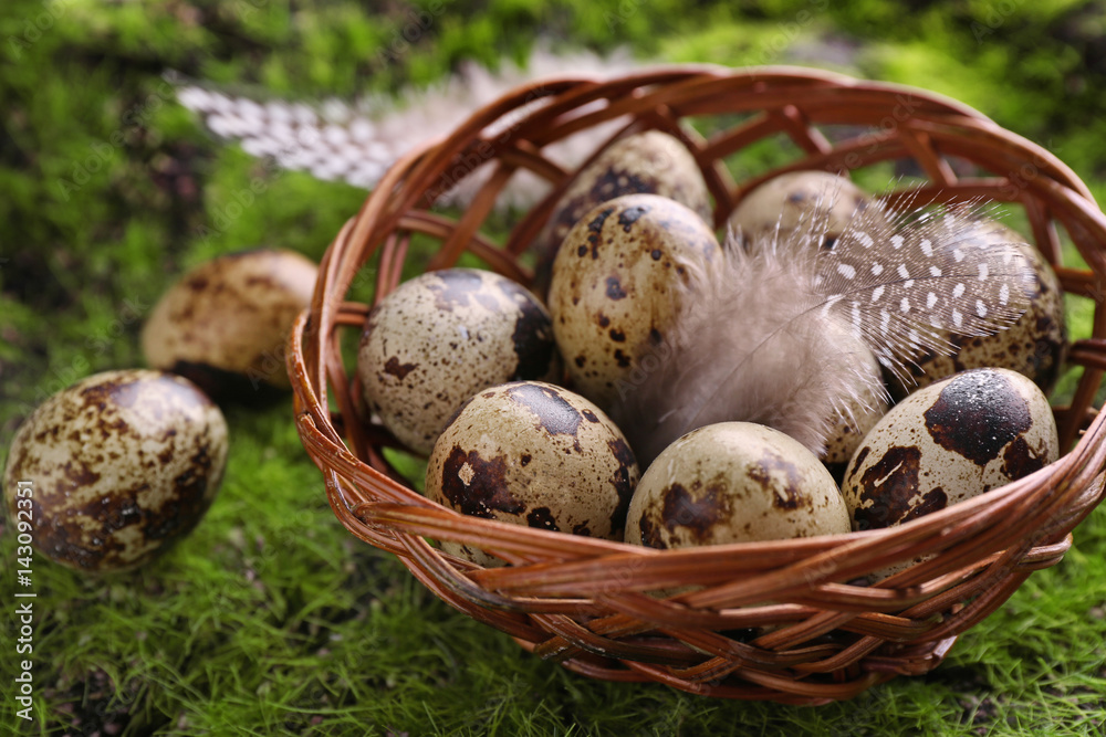 Easter eggs in wicker bowl on green background Easter eggs in wicker bowl on green background