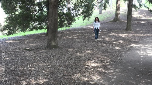 Wallpaper Mural mature woman walking in forest of pine trees Torontodigital.ca