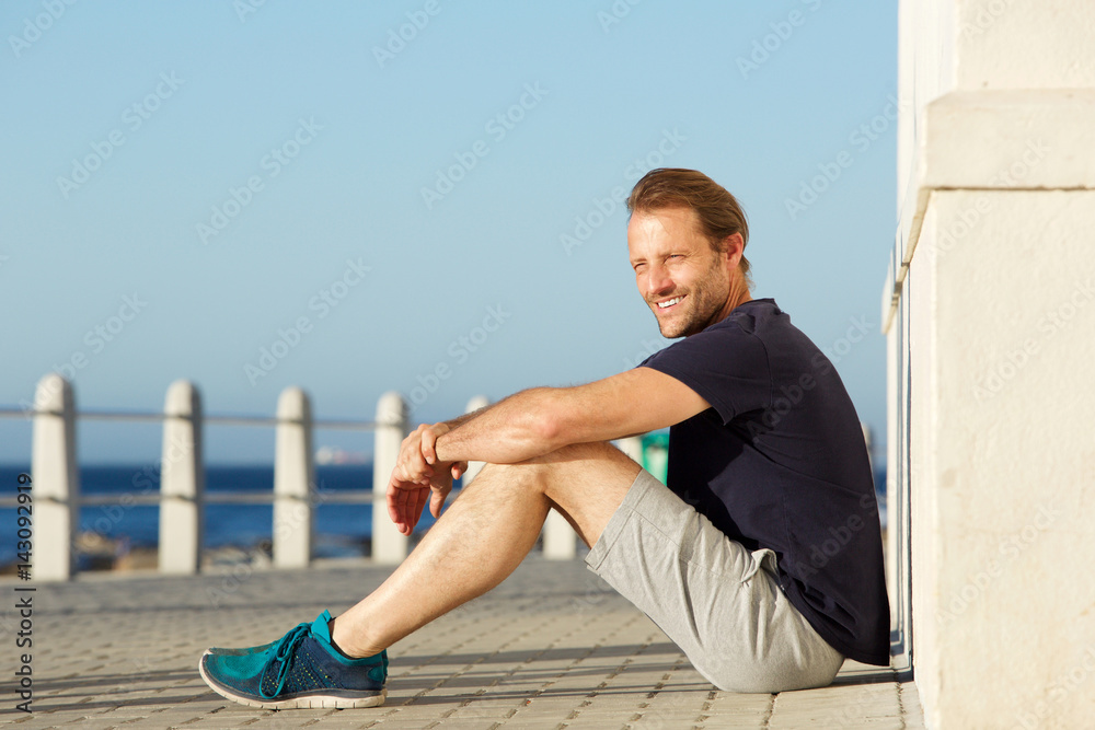 active middle age man sitting outside and smiling