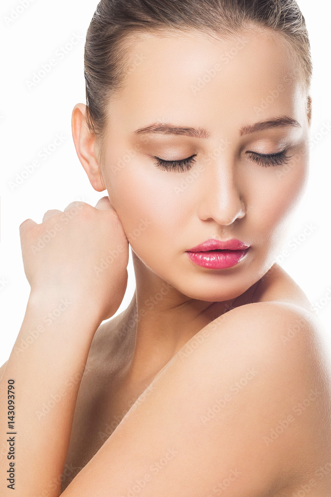Fototapeta premium Beauty Woman Portrait. Beautiful Spa Girl Touching her Face. Perfect Fresh Skin. Pure Beauty Model Female looking at camera. Youth and Skin Care Concept. Isolated on white background