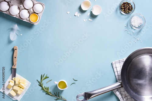 Cooking frame. Ingredients for preparing breakfast with eggs in a frying pan. Top view, text space. Flat lay.