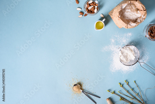 Baking ingredients for pastry on the blue background. Cooking cakes or bread concept. Top view, copy space.