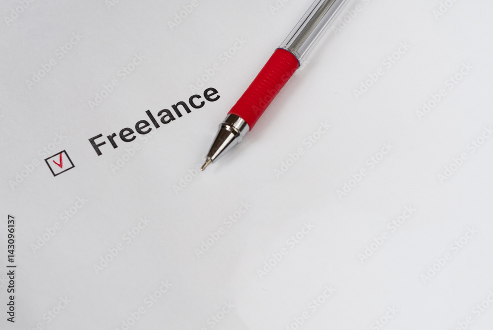Questionnaire. Red pen and the inscription Freelance with check mark on the white paper Questionnaire. Red pen and the inscription Freelance with check mark on the white paper