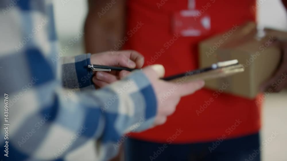 Unrecognizable delivery driver bringing package to a customer's door Unrecognizable delivery driver bringing package to a customer's door