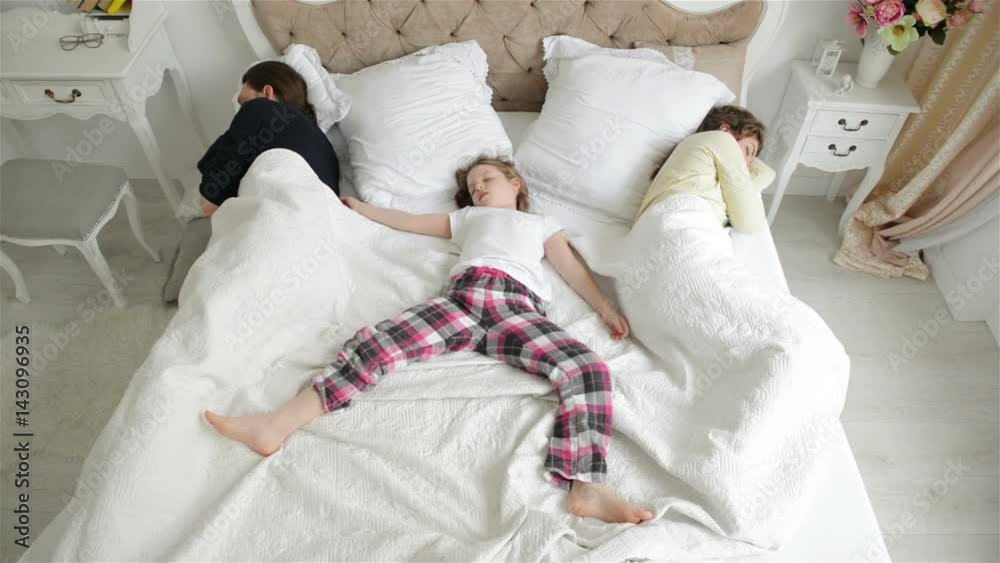 Little Girl is Lying on the Main Part of the Parents Bed, Mother and