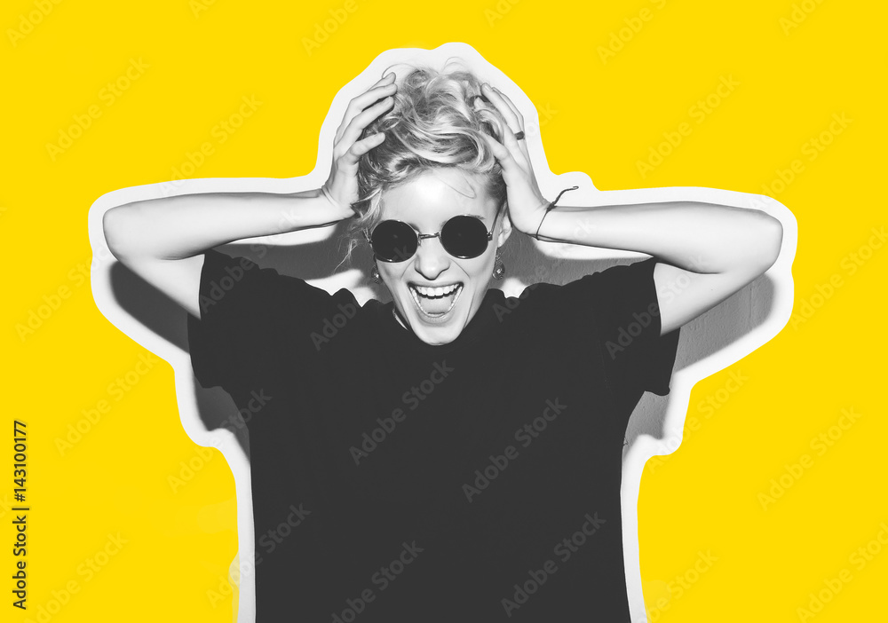 Stylish fashion blonde with short hair colorful collage. Crazy girl in a black t-shirt and rock sunglasses scream holding her head. Rocky emotional woman. white toned. yellow background, not isolated