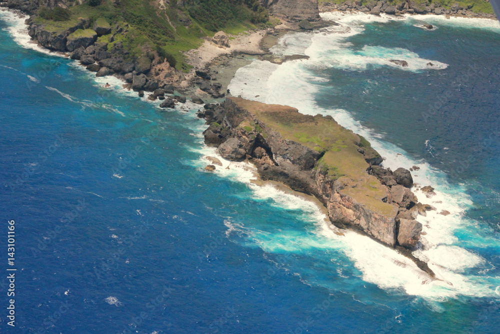 Aerial view of Forbidden Island, Saipan Surrounded by blue skies and