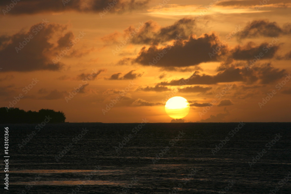 Golden ball A huge golden ball sets in the horizon. Saipan, Northern Mariana Islands