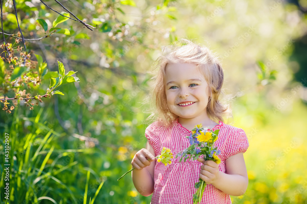 Happy little girl playing with bouquet in sunny park Happy little girl playing with bouquet in sunny park