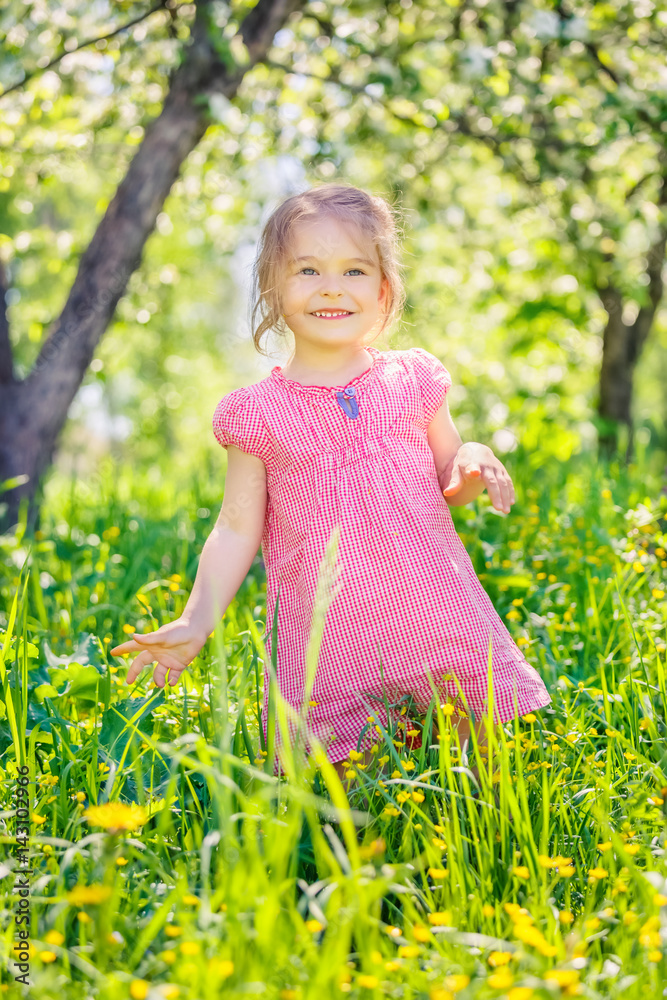 Happy little girl playing in sunny spring garden Happy little girl playing in sunny spring garden