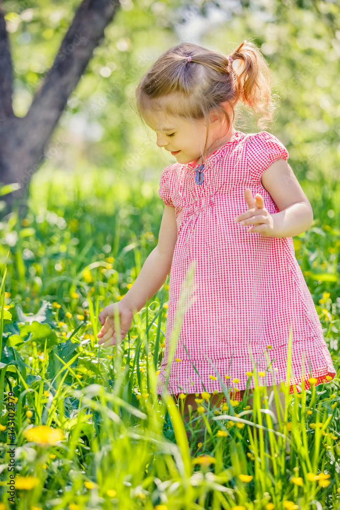 Happy little girl playing in sunny spring garden Happy little girl playing in sunny spring garden