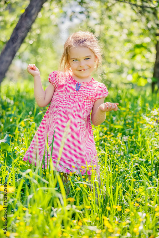 Happy little girl playing in sunny spring garden Happy little girl playing in sunny spring garden