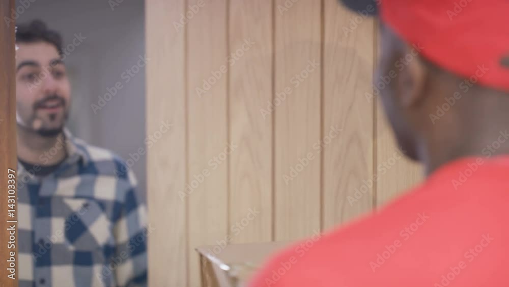  Delivery driver knocking on door & delivering package to customer