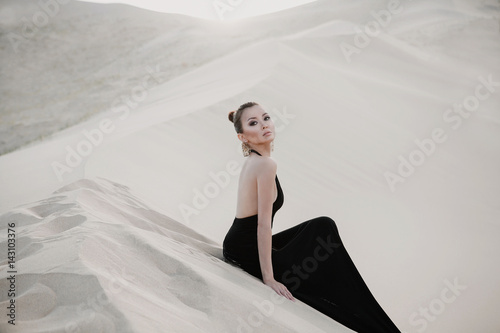 Beautiful sexy asian woman model on a dune of desert photo