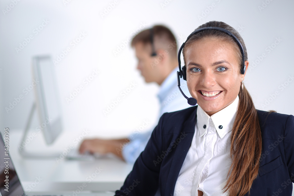 Happy female wearing headset and sitting on the desk Happy female wearing headset and sitting on the desk
