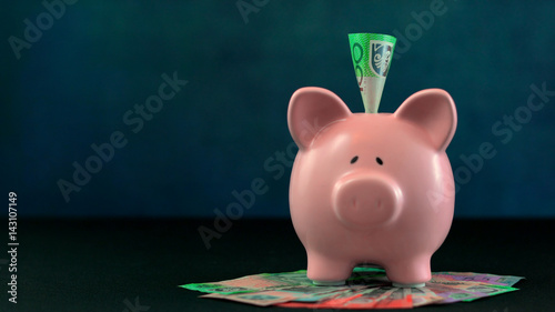 Принти на полотні Pink Piggy bank money concept on dark blue background