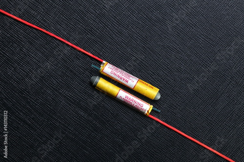 Obraz na płótnie Rocket firework close up photo on the black color leather surface as a background represent the celebration explosive material