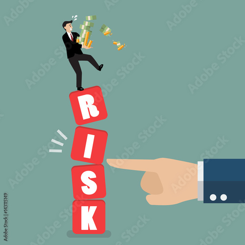Businessman standing on shaky risk blocks by hand of enemy
