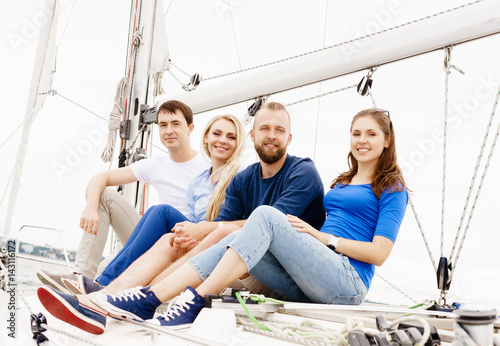 Group of happy friends traveling on a yacht. Tourism, vacation, holiday, concept. © Acronym