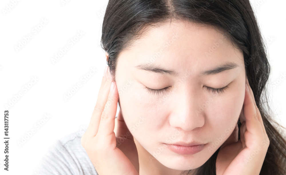 Closeup woman hand closes her ears with white background Closeup woman hand closes her ears with white background
