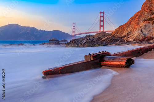 Golden Gate Bridge in San Francisco from Baker Beach at sunset photo