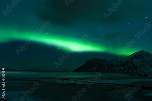 Aurora Borealis Known as Nother Lights Playing with Vivid Colors Over Lofoten Islands in Norway.