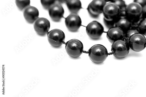 Black beads on a white background