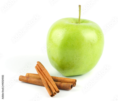 Green apple with cinnamon isolated on white background