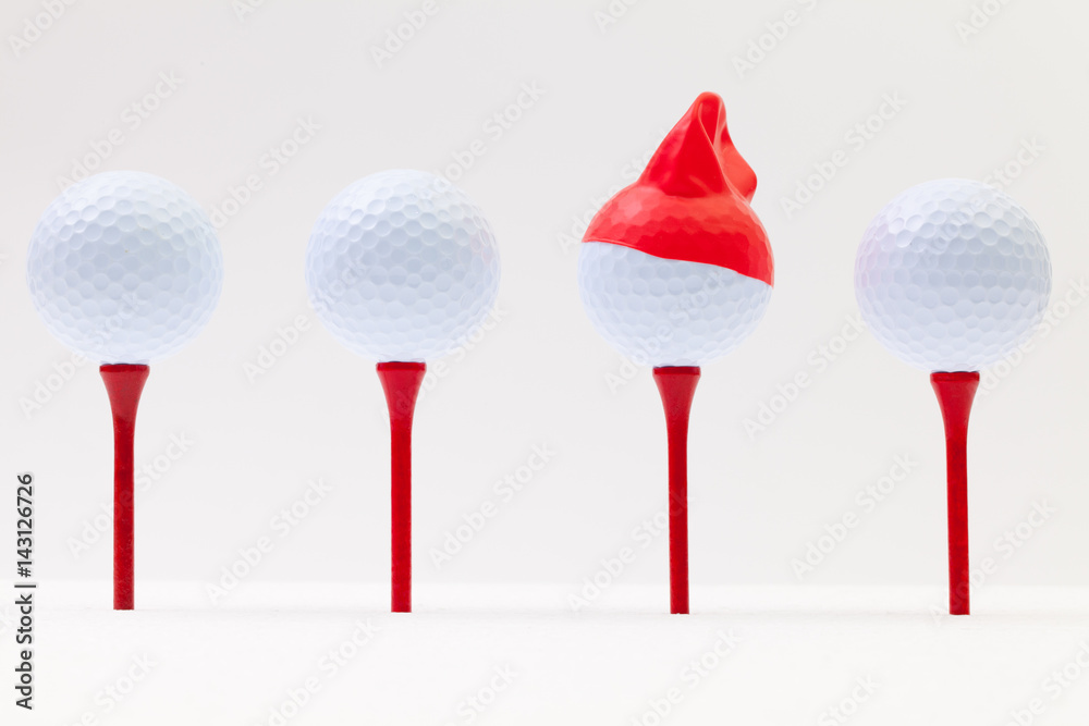 White golf balls with funny cap. Funny golf concept. White golf balls with funny cap. Funny golf concept.