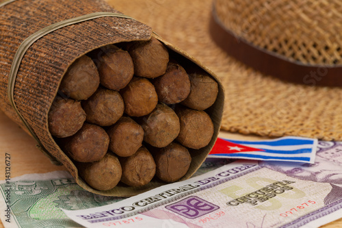Siesta - cigars, straw hat and Cuban banknotes