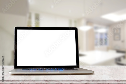 Laptop on marble top table and blurred Kitchen  background. for Graphic or Procuct display montage.