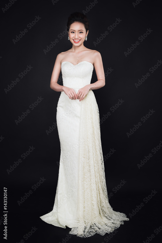 Full length of smart asian lady wearing white dress Full length of smart asian lady wearing white dress