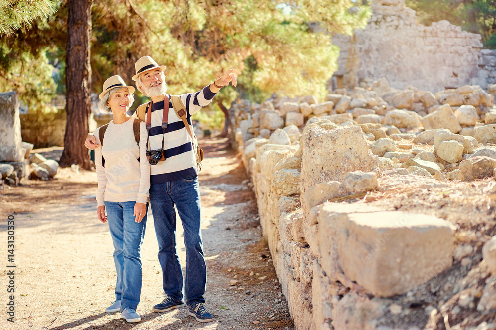 Travel and tourism. Senior family couple walking together on ancient sighseeing.