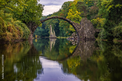 Autumn, cloudy evening over Devil's bridge in the park Kromlau, Germany © Mike Mareen