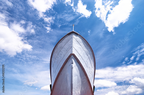 The nose of big ship against cloudy sky. photo