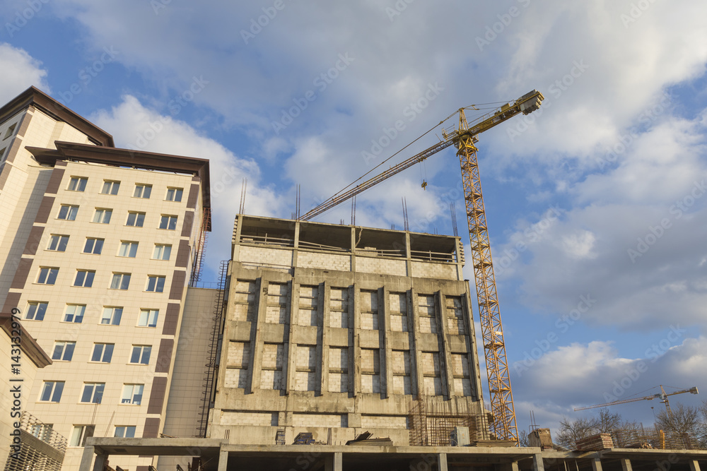 Architecture and Construction Concepts and Ideas. Industrial Construction Site With Mid-Size Crane In Process.