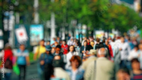 Wallpaper Mural Crowd of People / Commuters Walking / Busy Street. Anonymous crowd on a busy street. People walk down a busy street with green trees on a hot summer day. Slow motion. Torontodigital.ca