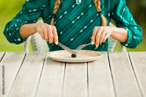 Young lonely woman is having meager meal in times of scarcity. 